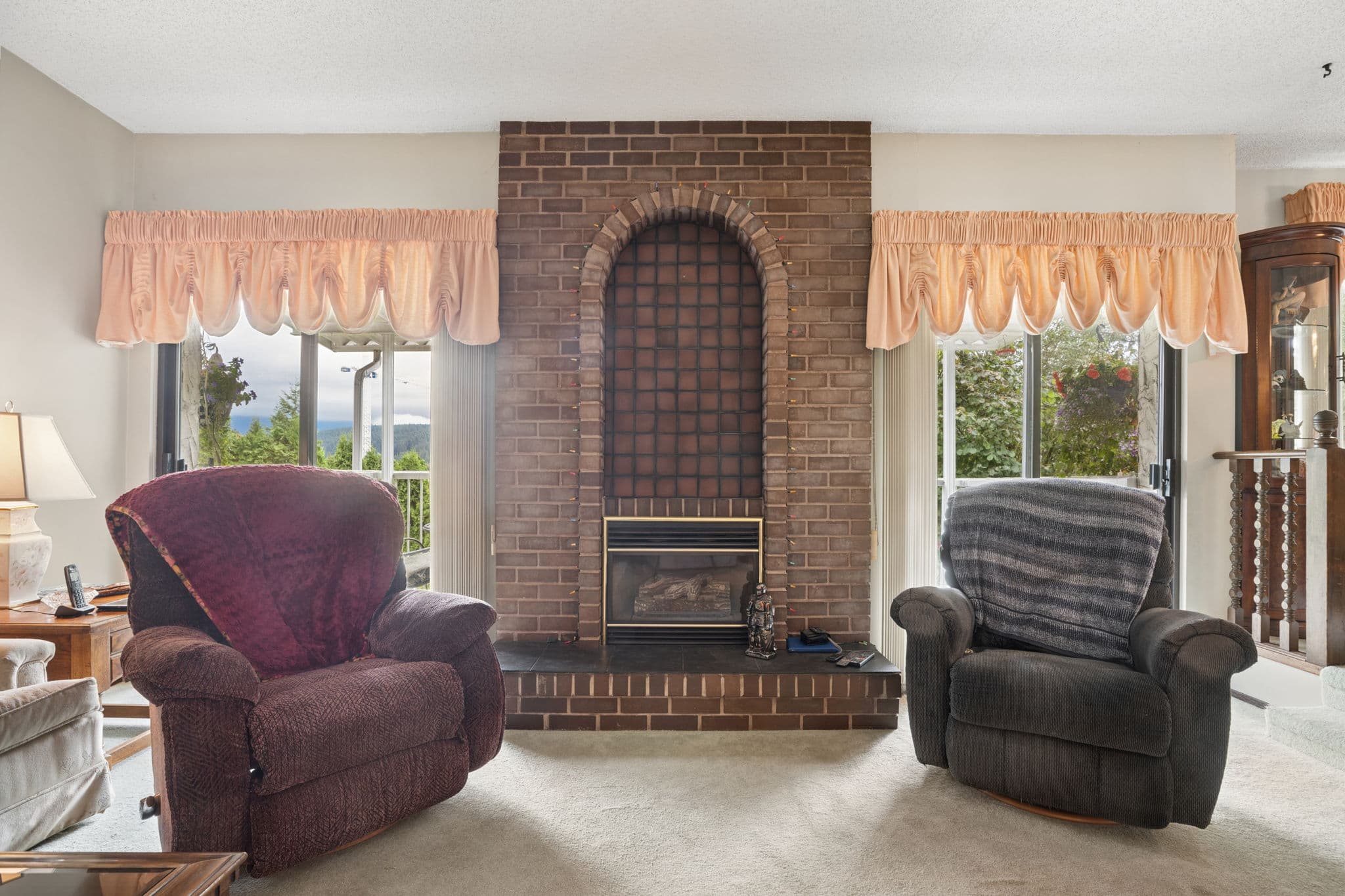 Family room with brick fireplace and mountain-view windows