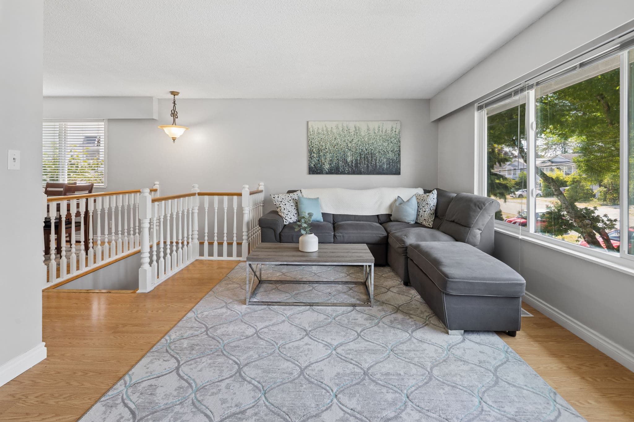 Bright upper-level living room open to the entry and staircase