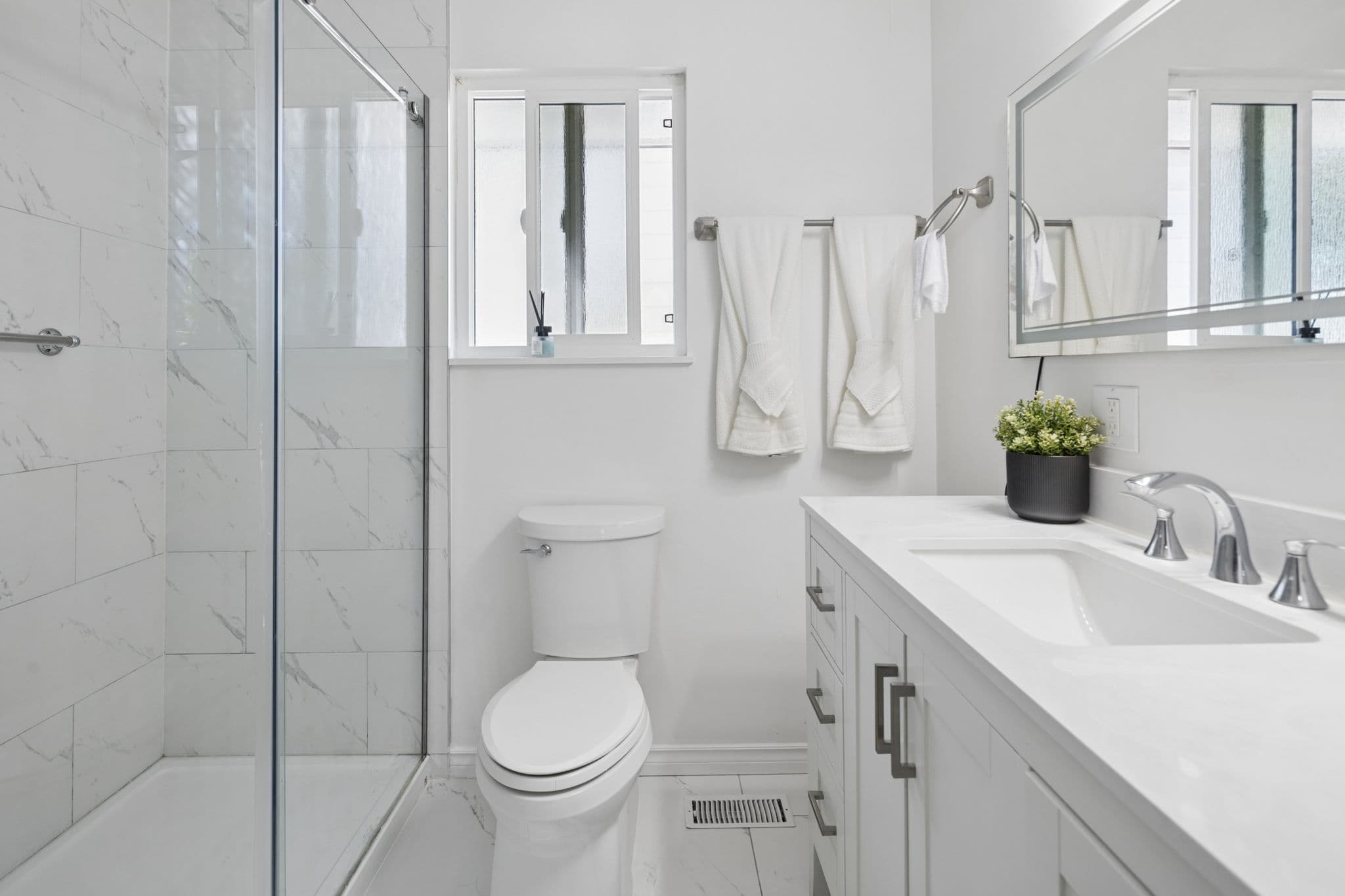 Renovated main bathroom with marble-tile walk-in shower